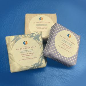 3 soaps wrapped in colourful wrapping paper, there is a sticker on the paper saying "No ordinary soap" Lavender and sea salt, natural beeswax